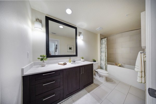 Bathroom with sleek fixtures and marble countertops at Solle Davie Luxury Apartments