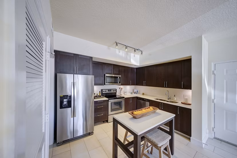 Modern kitchen with stainless steel appliances at Solle Davie Luxury Apartments, showcasing stylish design and functionality