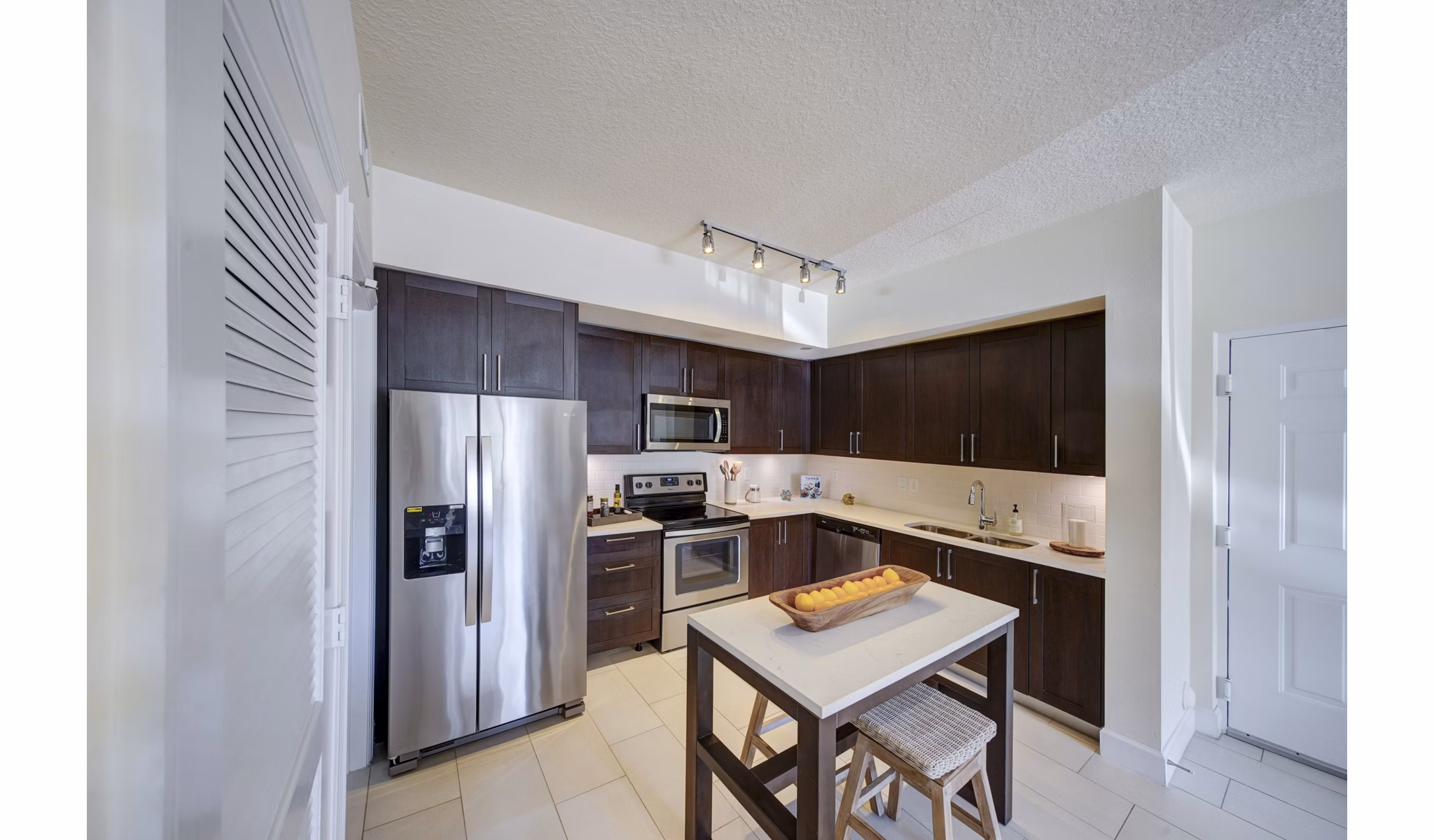 Modern kitchen with stainless steel appliances at Solle Davie Luxury Apartments, showcasing stylish design and functionality