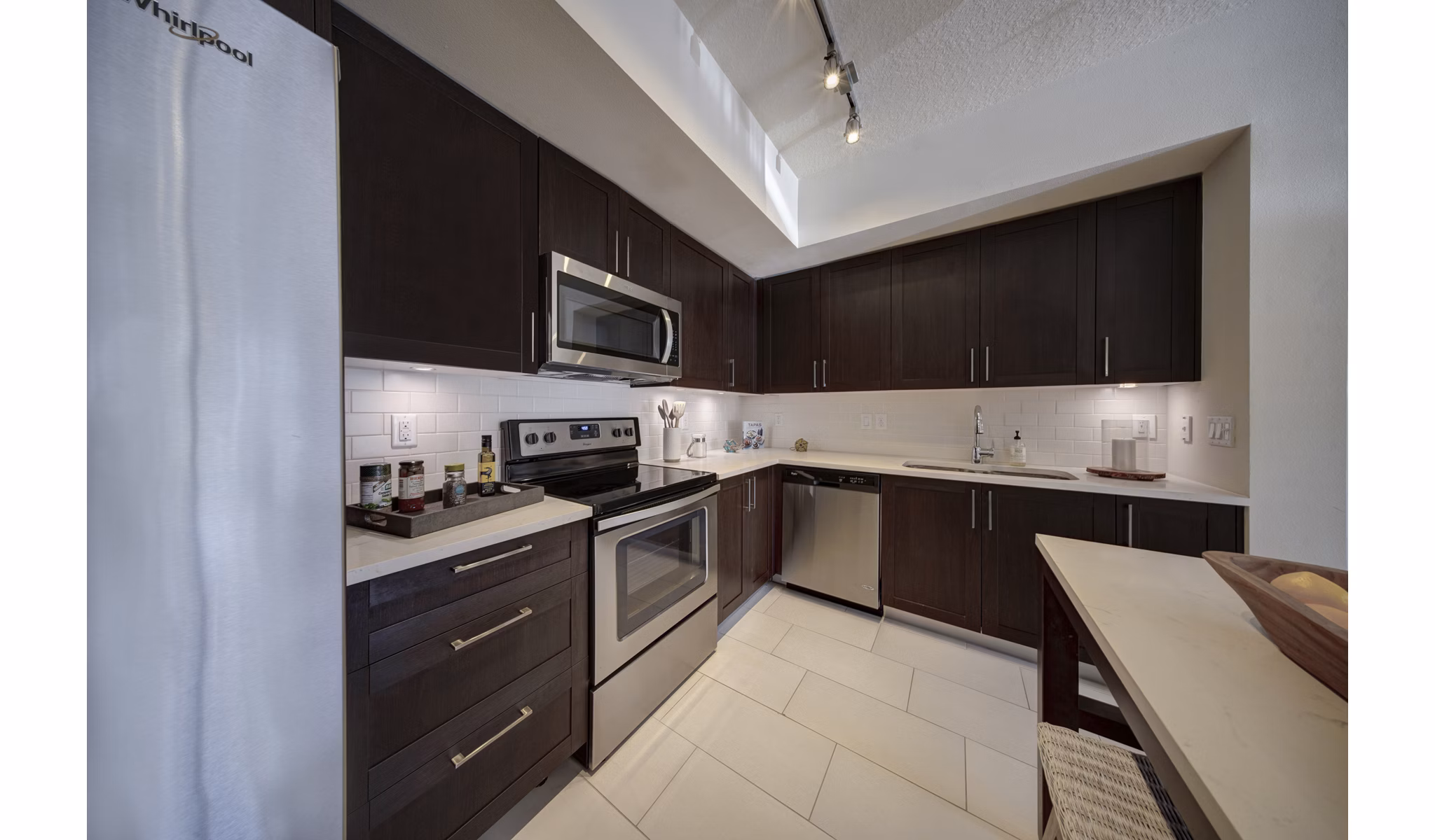 Modern kitchen with sleek countertops and stainless steel appliances at Solle Davie Luxury Apartments