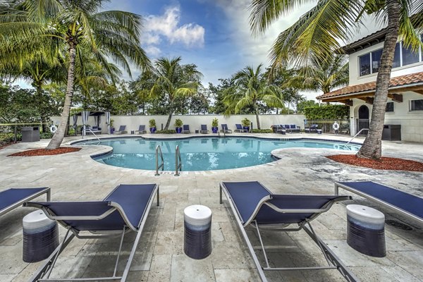 Resort-style pool with palm trees and lounge chairs at Solle Davie Luxury Apartments