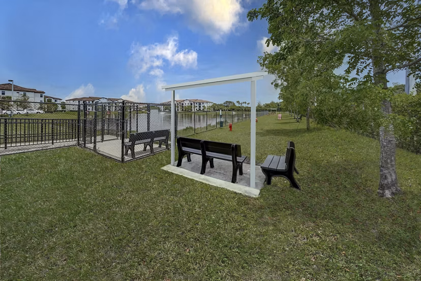 Spacious dog park at Solle Davie luxury apartments featuring agility equipment and open play areas
