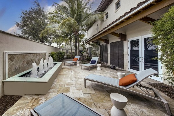 Spacious outdoor patio with modern seating at Solle Davie Luxury Apartments