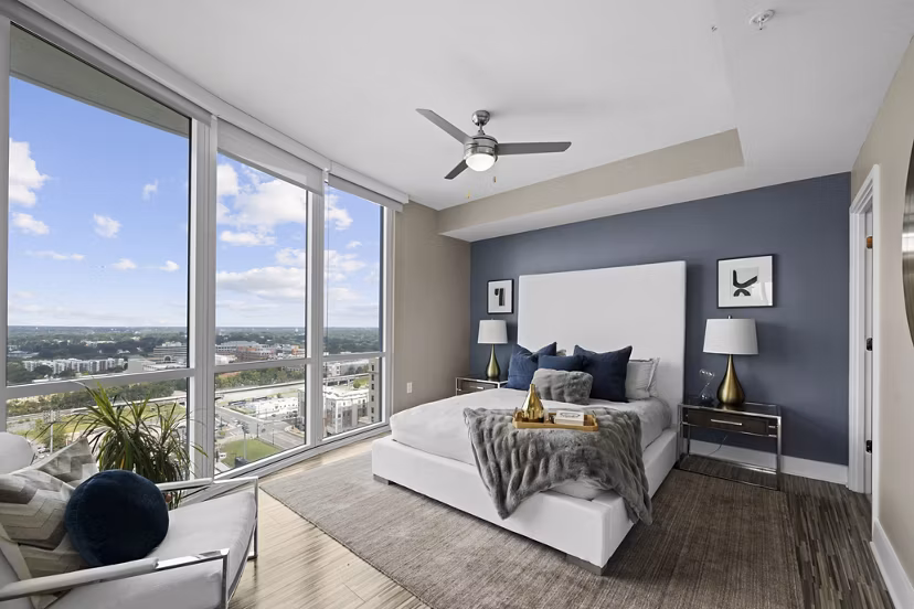 Modern bedroom with city views at Ascent Uptown Apartments