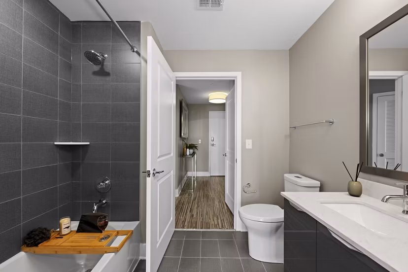 Bathroom featuring modern fixtures and sleek design at Ascent Uptown Apartments