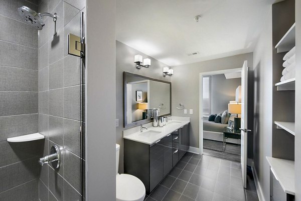 Bathroom featuring modern fixtures and sleek design at Ascent Uptown Apartments