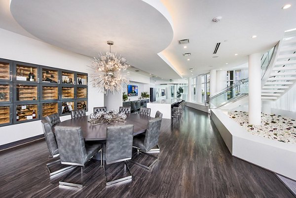 Wine cellar with elegant lighting at Ascent Uptown Apartments clubhouse