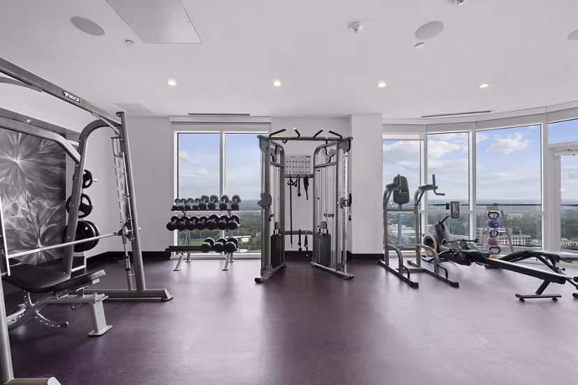 Modern fitness center with state-of-the-art equipment at Ascent Uptown Apartments, ideal for active lifestyles and luxurious living
