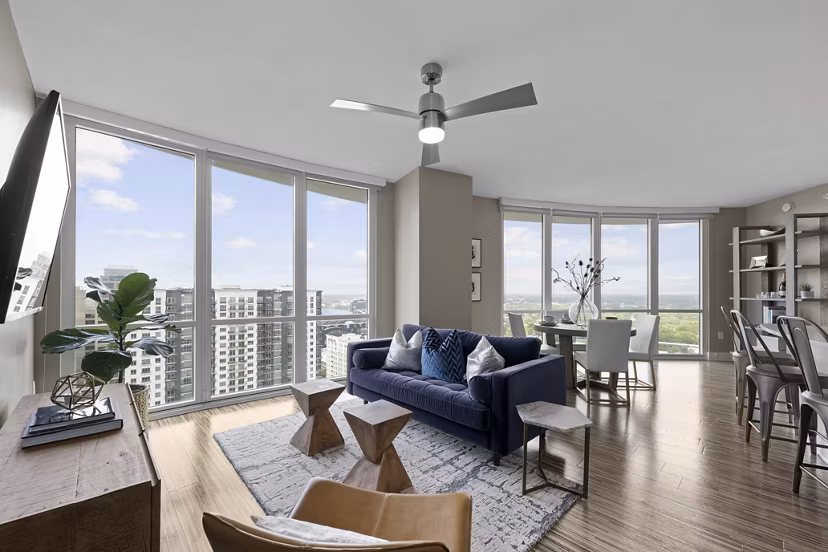 Spacious living room at Ascent Uptown Apartments featuring modern decor and natural light