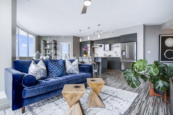 Spacious living room at Ascent Uptown Apartments featuring modern decor and natural light