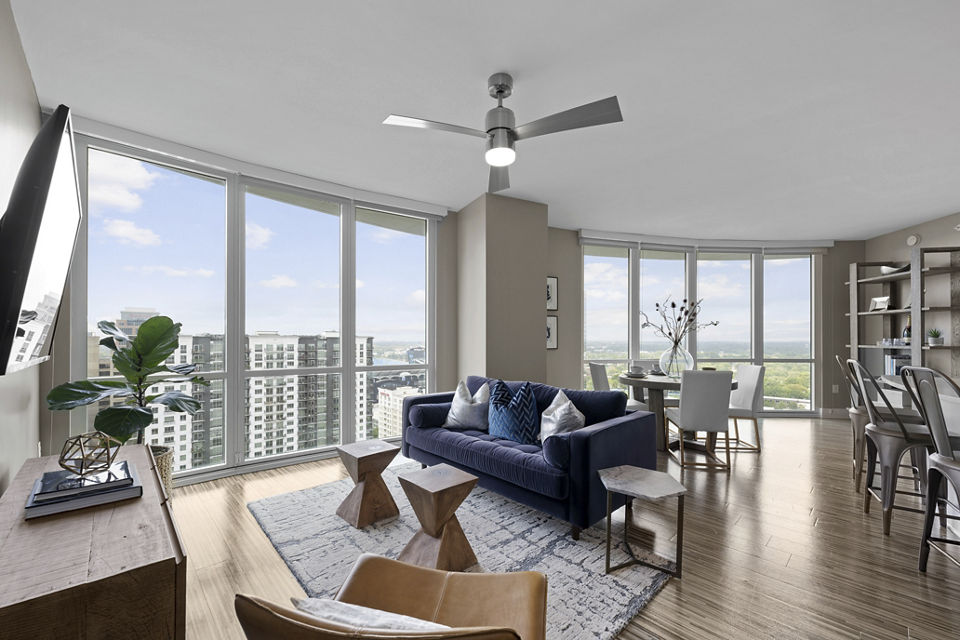 Spacious living room at Ascent Uptown Apartments featuring modern decor and natural light