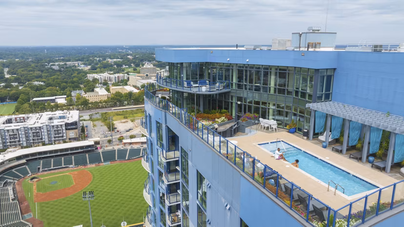 Scenic rooftop deck with modern seating at Ascent Uptown Apartments, offering city skyline views