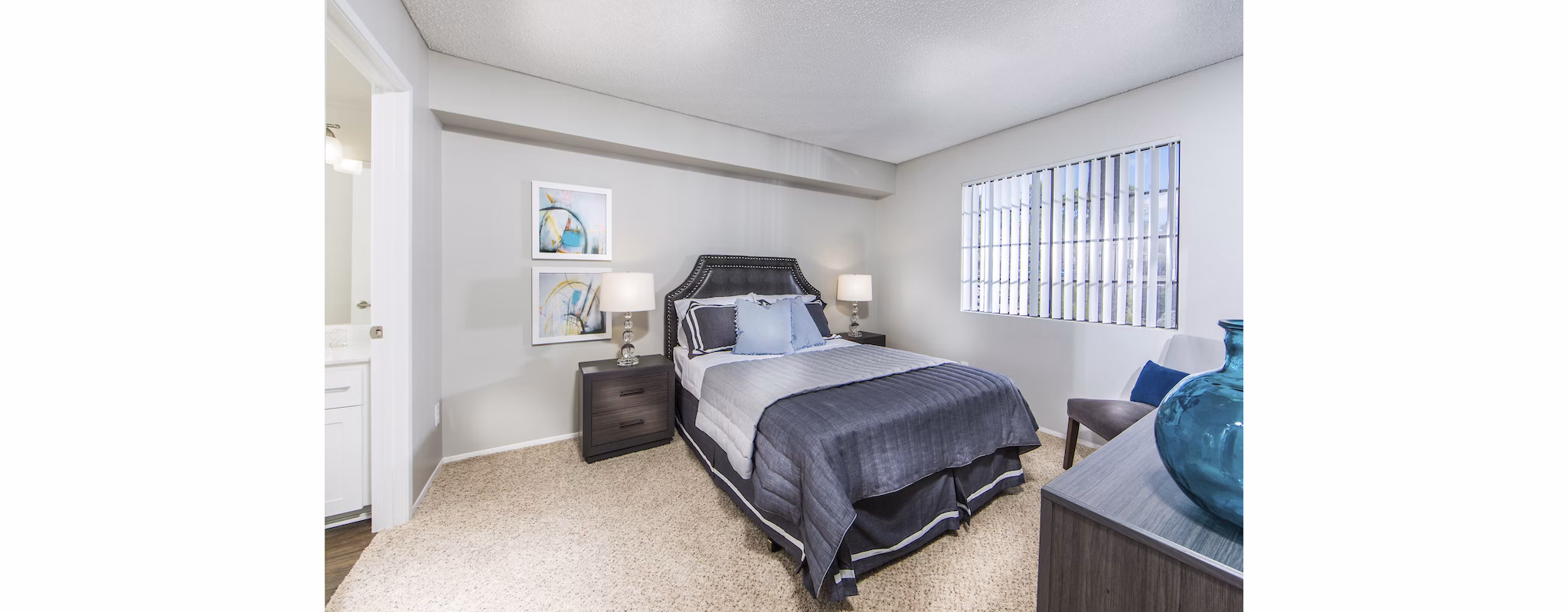 Bedroom at Hacienda Vallecitos Apartments featuring elegant design and cozy furnishings