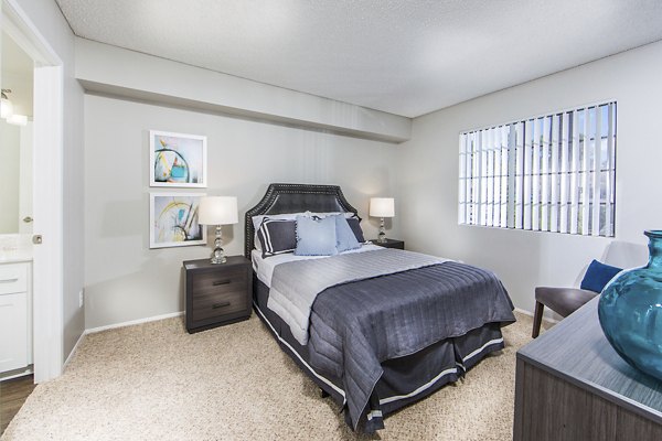 Bedroom at Hacienda Vallecitos Apartments featuring elegant design and cozy furnishings