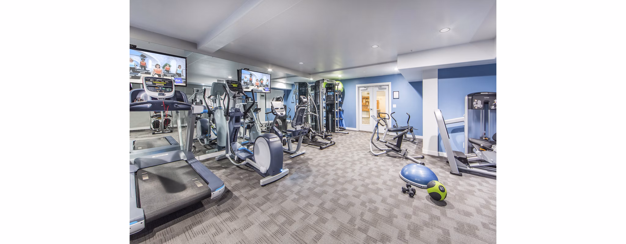 Modern fitness center with state-of-the-art equipment at Hacienda Vallecitos Apartments for luxury living