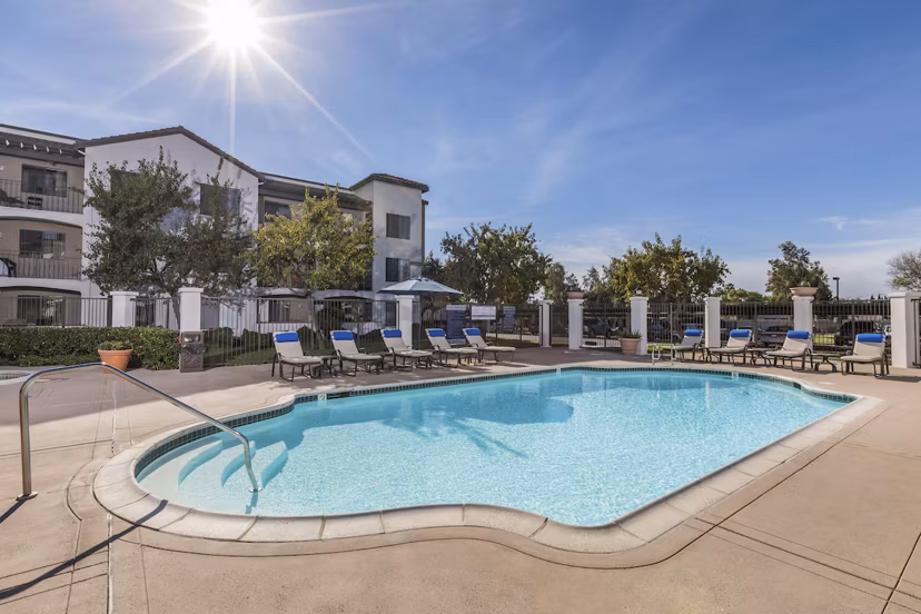 Expansive outdoor pool with lounge seating at Overture San Marcos Apartment Homes