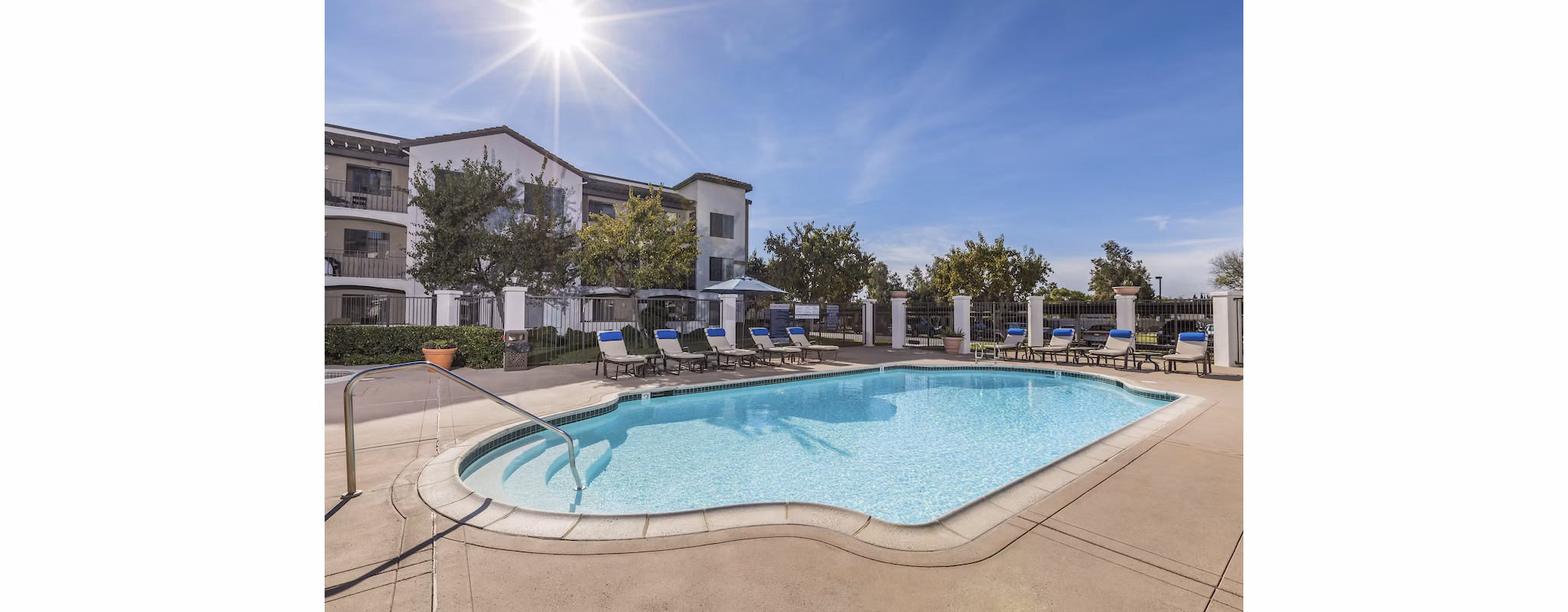 Expansive outdoor pool with lounge seating at Overture San Marcos Apartment Homes