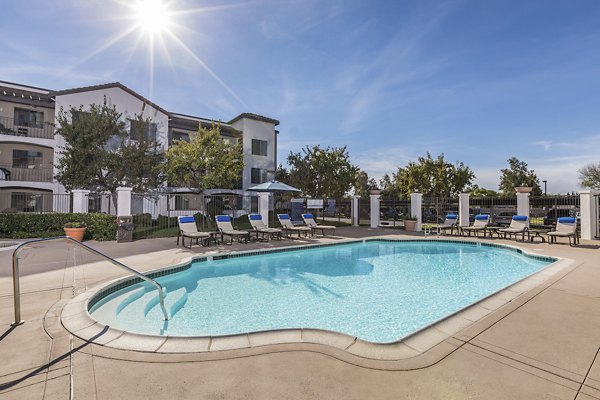 Expansive outdoor pool with lounge seating at Overture San Marcos Apartment Homes