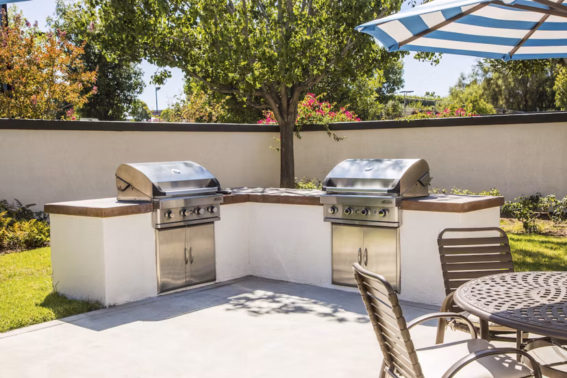 Grill area with modern BBQ facilities at Hacienda Vallecitos Apartments