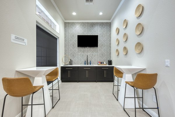 Clubhouse featuring contemporary design and spacious seating at Parc at Wall Street Apartments