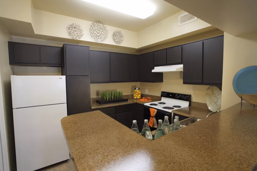 Modern kitchen with stainless steel appliances in Parc at Wall Street Apartments