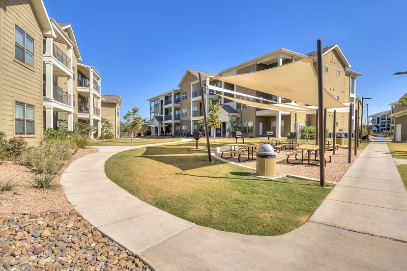Outdoor BBQ area featuring modern grills at La Contessa Apartments
