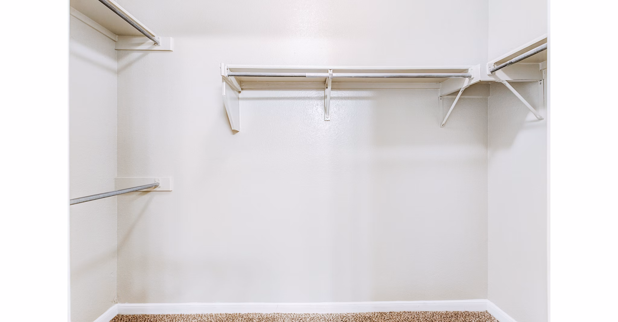 Walk-in closet with ample storage in Riviera at West Village Apartments, luxury living