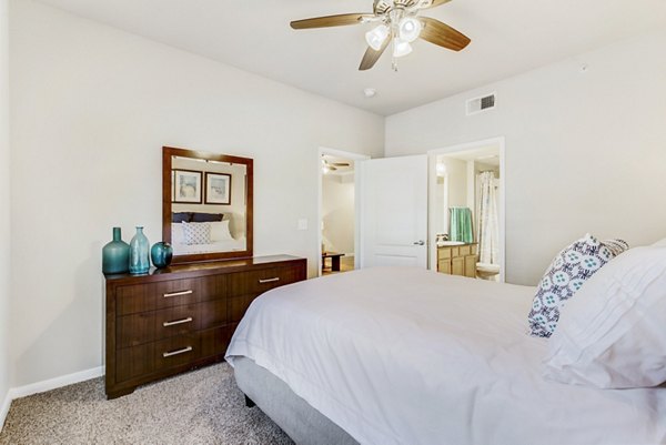 Cozy bedroom featuring modern decor at Riviera at West Village Apartments, Greystar luxury apartments in a convenient location