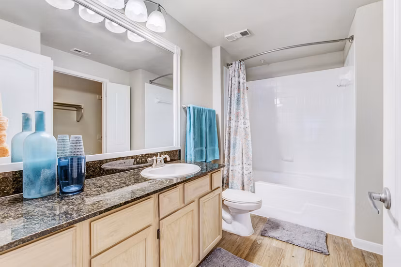 Modern bathroom with marble countertops at Riviera at West Village Apartments
