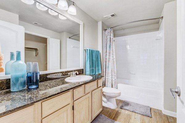 Modern bathroom with marble countertops at Riviera at West Village Apartments