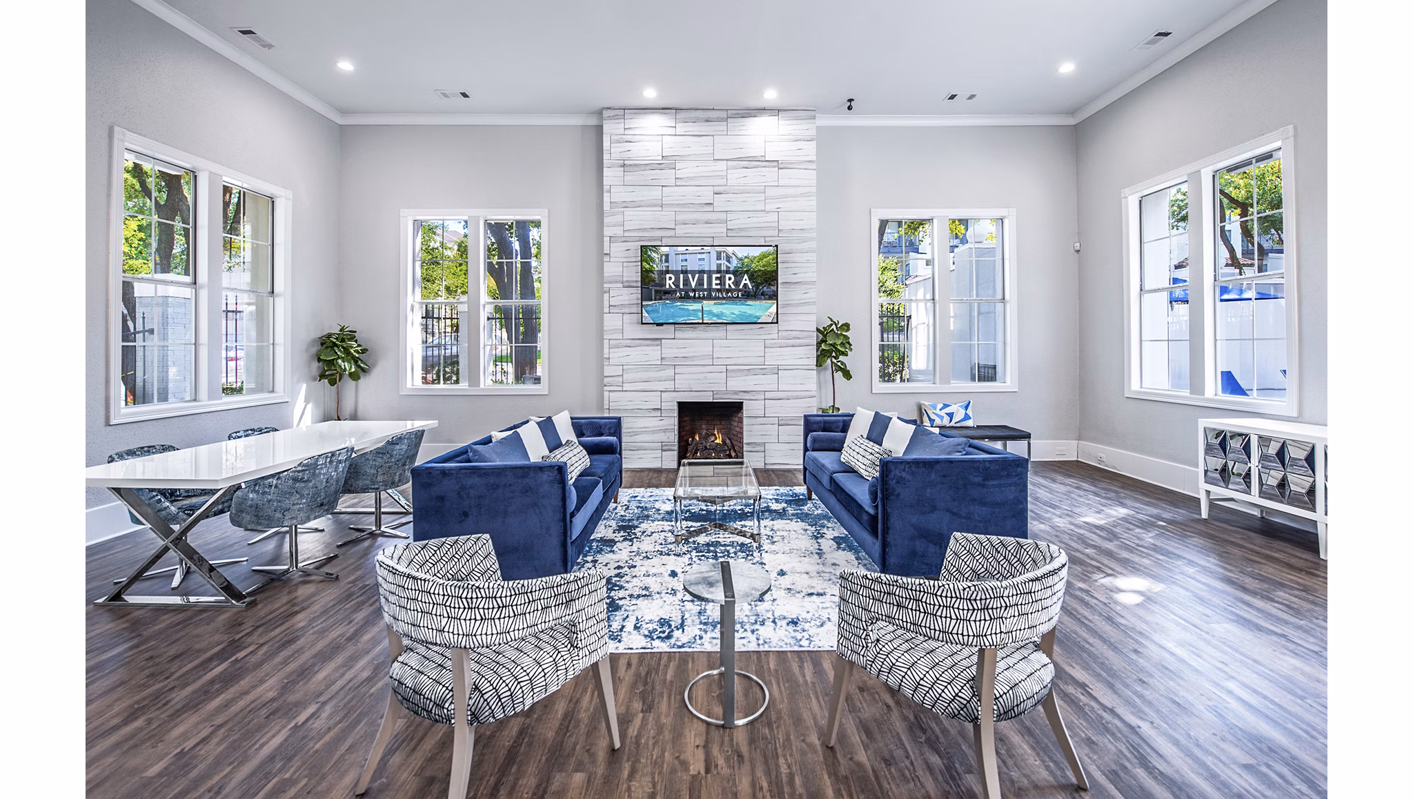 Elegant clubhouse lobby with contemporary furnishings in Riviera at West Village Apartments