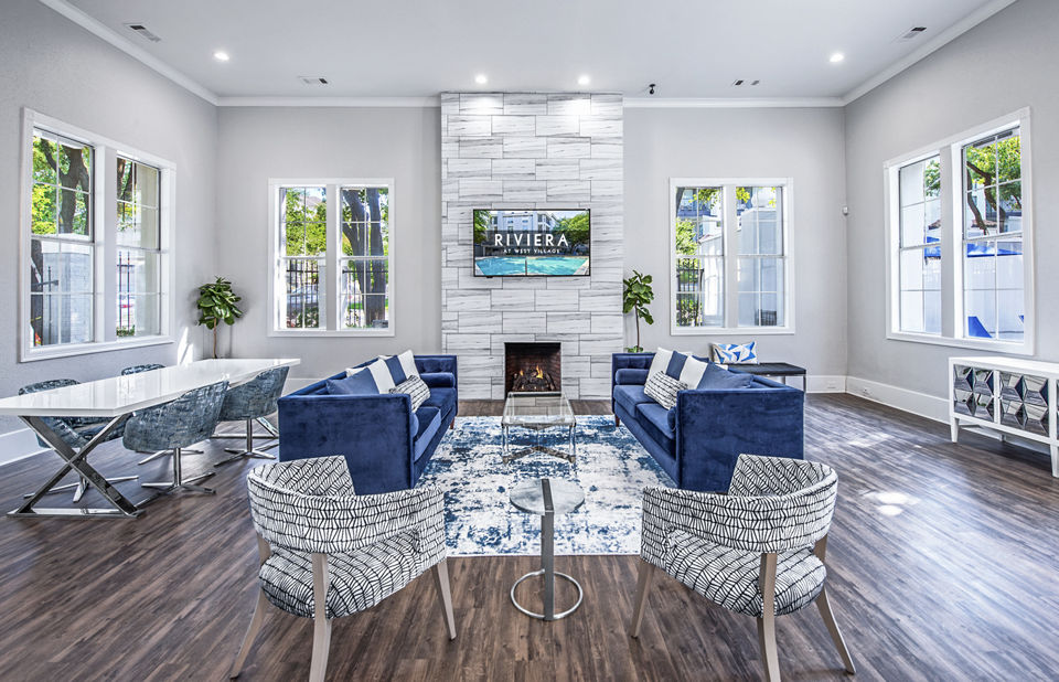 Elegant clubhouse lobby with contemporary furnishings in Riviera at West Village Apartments