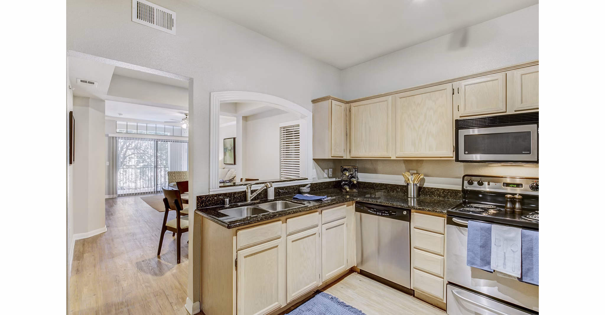 Modern kitchen with stainless steel appliances at Riviera at West Village Apartments