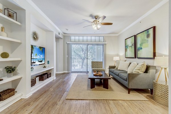 Contemporary living room with sleek furniture in Riviera at West Village Apartments