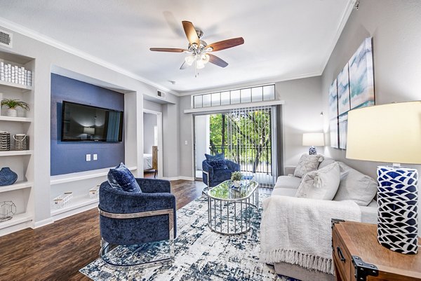 Living room with plush seating and modern decor at Riviera at West Village Apartments