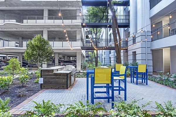 Grill area with modern seating at Riviera at West Village Apartments, a premier location for luxury living and outdoor entertaining