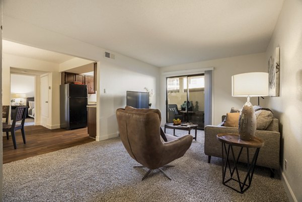 Modern living room with stylish decor and abundant natural light at The Reserve Apartments