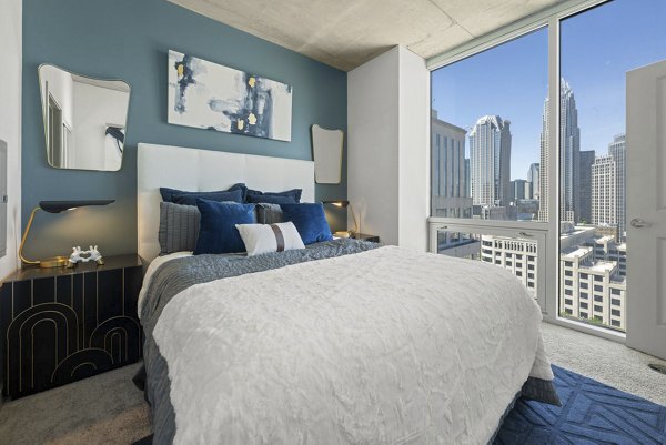 Contemporary bedroom featuring minimalist decor at Skyhouse Uptown North Apartments