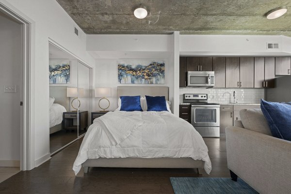Bedroom featuring modern decor and ample natural light at Skyhouse Uptown North Apartments