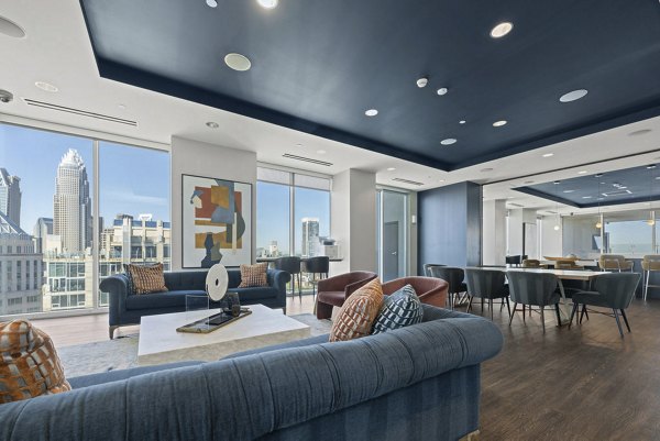 Clubhouse featuring modern decor and ample seating at Skyhouse Uptown North Apartments