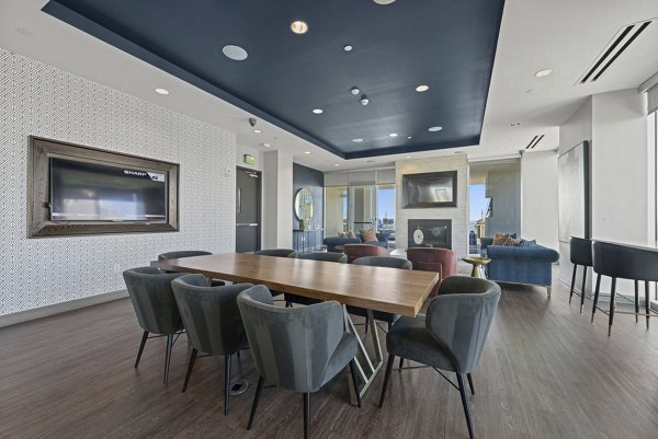 Clubhouse meeting facility with modern seating and conference table at Skyhouse Uptown North Apartments