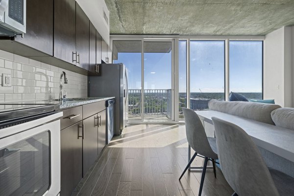 Modern kitchen with stainless steel appliances at Skyhouse Uptown North Apartments