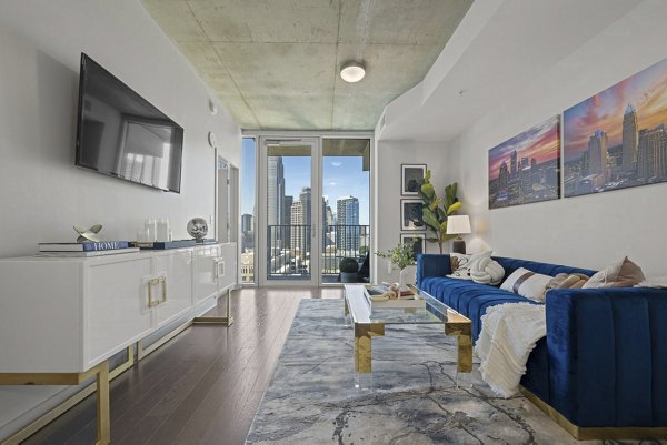 Spacious living room with modern decor at Skyhouse Uptown North Apartments
