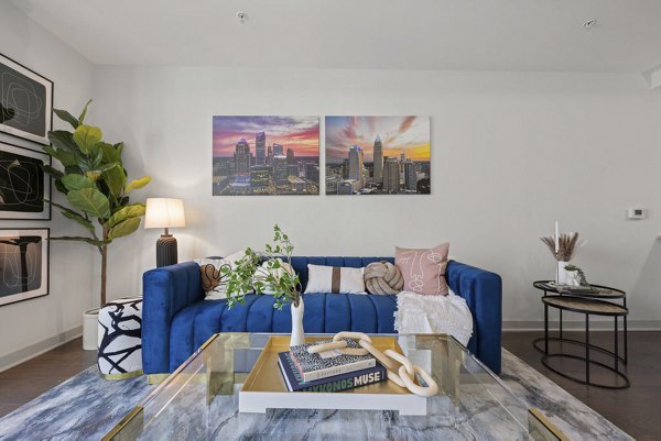 Skyhouse Uptown North Apartments: Modern living room with sleek furnishings and panoramic views