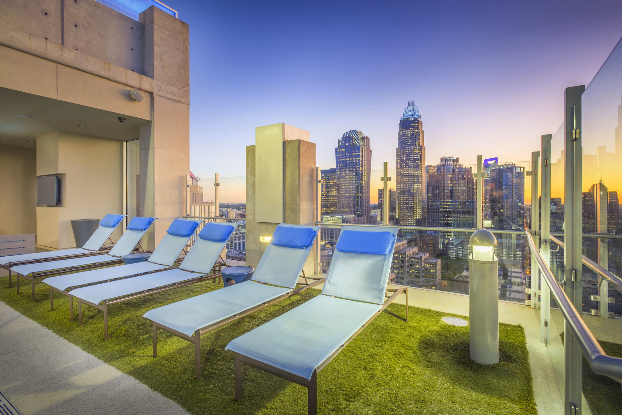 Scenic pool patio with modern lounge seating at Skyhouse Uptown North Apartments, a luxury community managed by Greystar