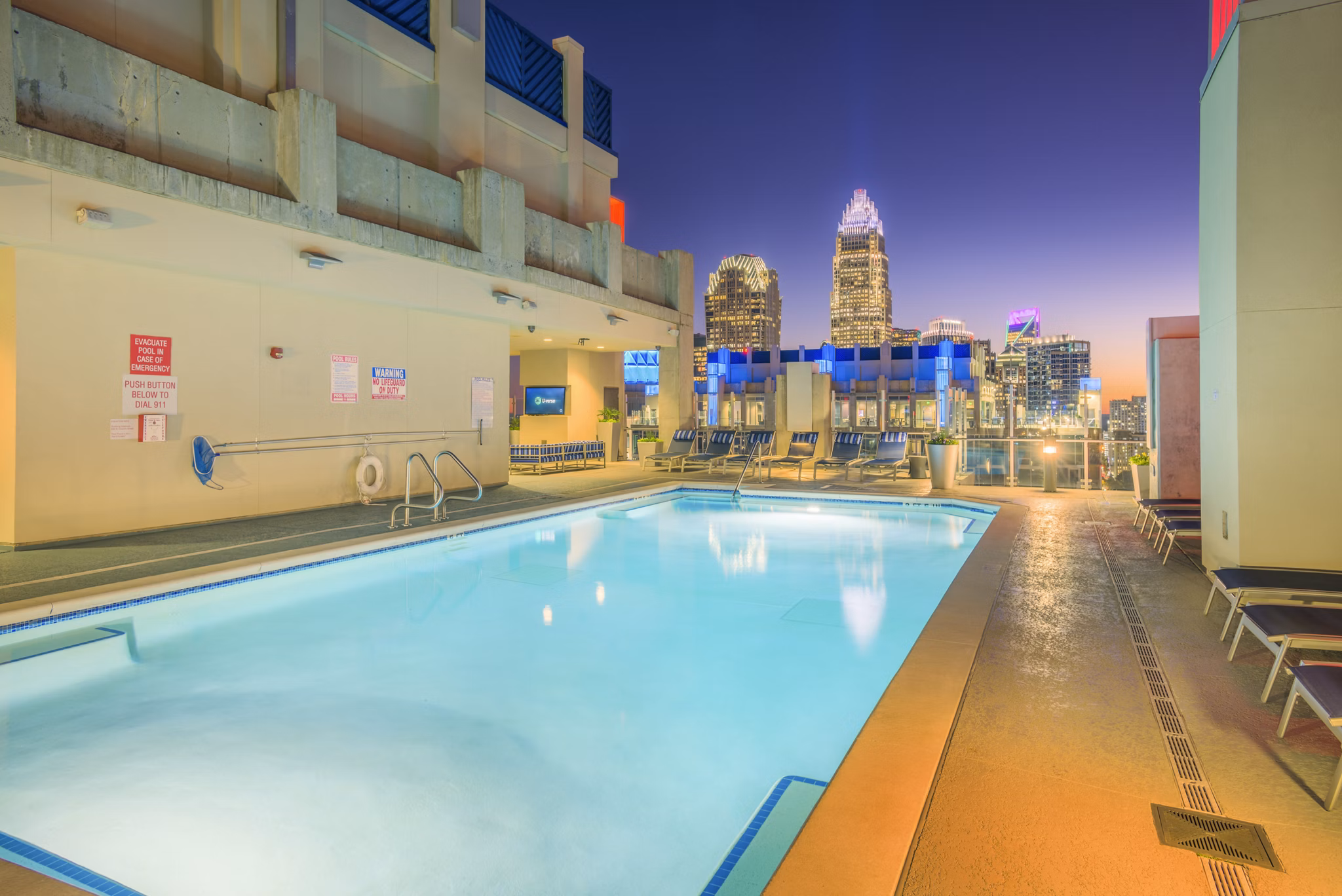 Rooftop pool with city skyline view at Skyhouse Uptown North Apartments
