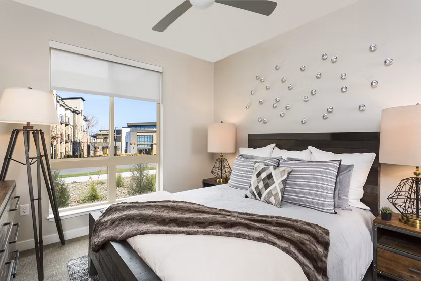 Cozy bedroom featuring modern decor and ample natural light at Solana Olde Town Station Apartments