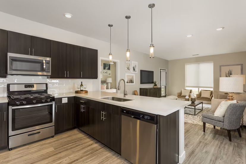 Modern kitchen with stainless steel appliances and granite countertops at Solana Olde Town Station Apartments, luxury living
