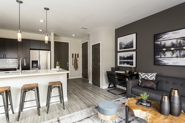Cozy living room with modern furnishings at Solana Olde Town Station Apartments in Olde Town, ideal for comfortable and stylish living
