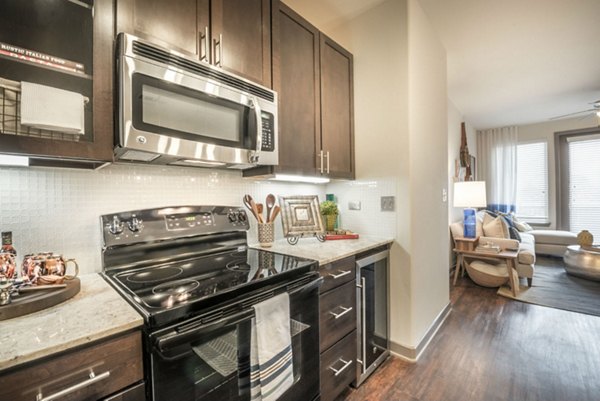 Modern kitchen with stainless steel appliances at Overture Flower Mound Apartments